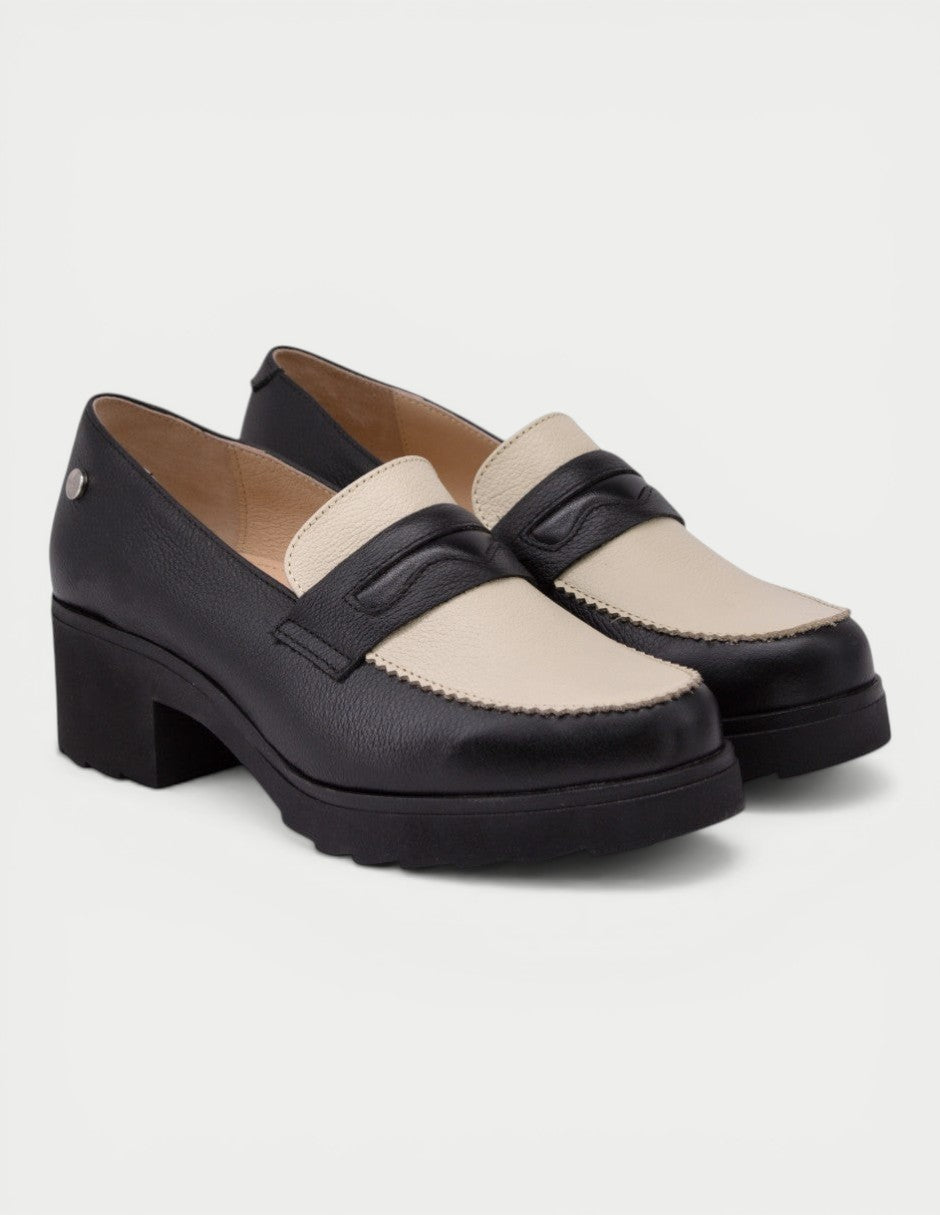 Manet black and cream leather two-tone loafers with block heel and decorative stitching.