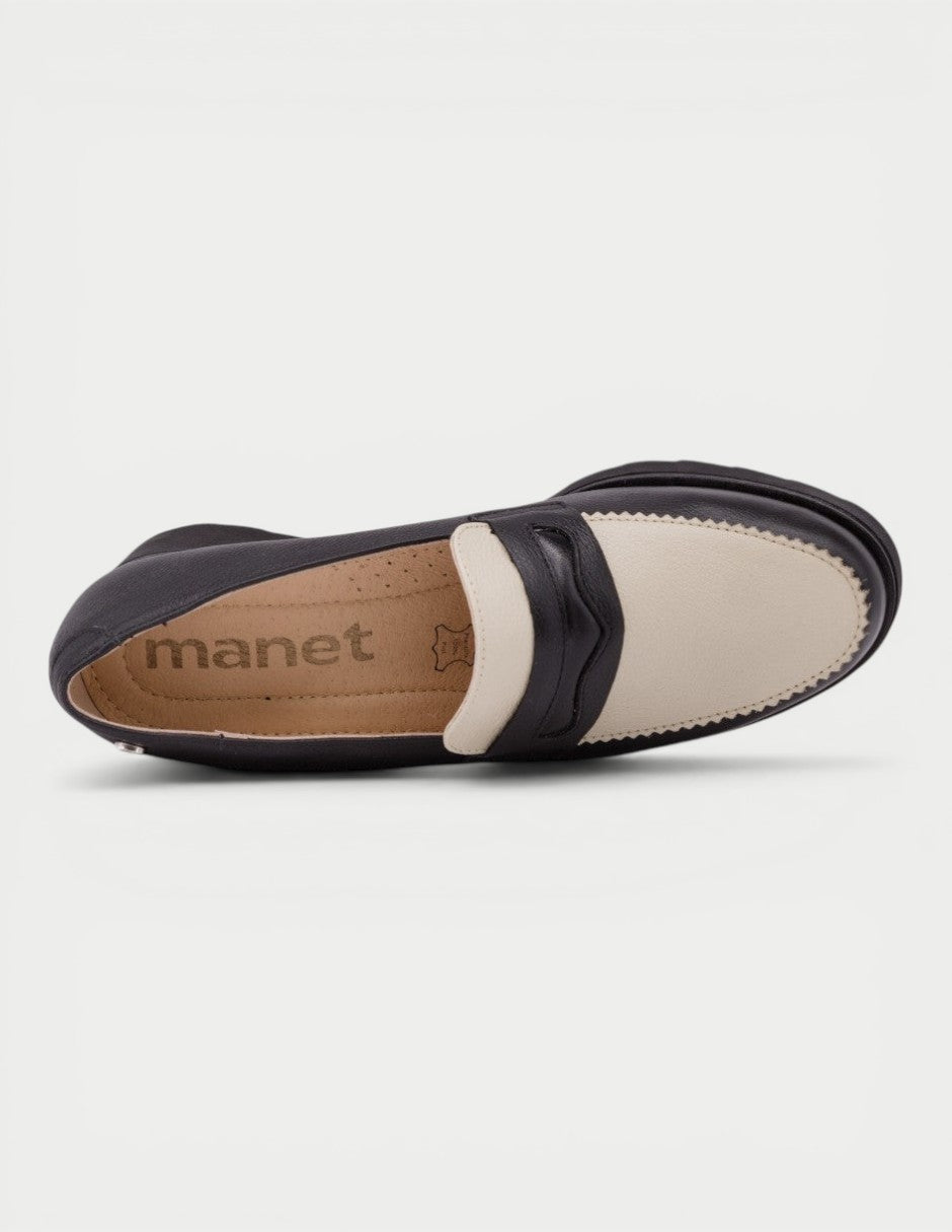Manet black and cream leather two-tone moccasin with a scalloped trim and discreet heel. Classic style for women.