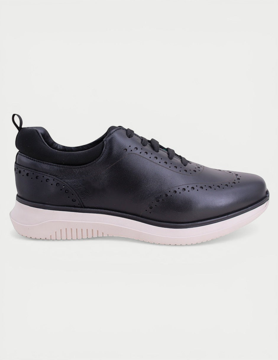 Manet Midas 02 black leather wingtip sneakers with white sole. Classic brogue detailing and modern design for men.