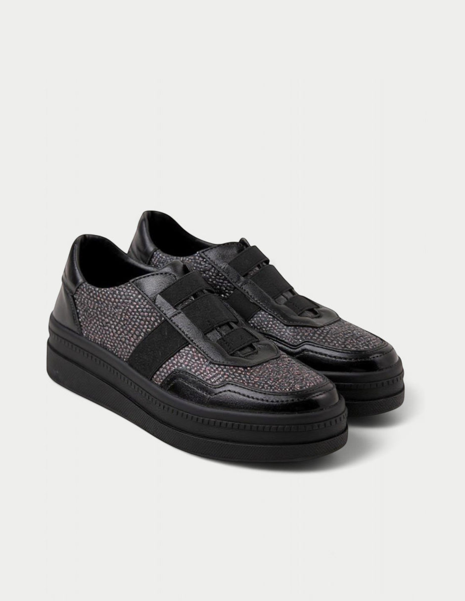 Manet Ema 01 black sneakers with textured stone-like details and elastic straps on a low platform.