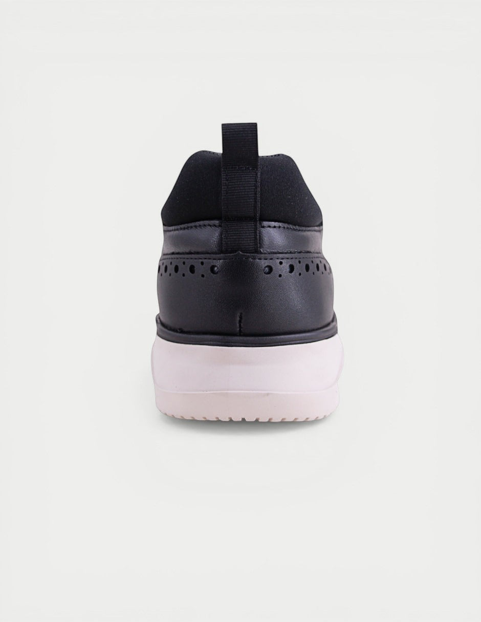 Manet Midas 02 black leather men's sneakers with brogue detailing and a white sole.