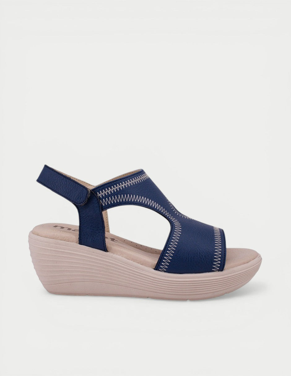 Manet navy blue leather wedge sandals with white contrast stitching and adjustable ankle strap. Comfortable everyday wear.