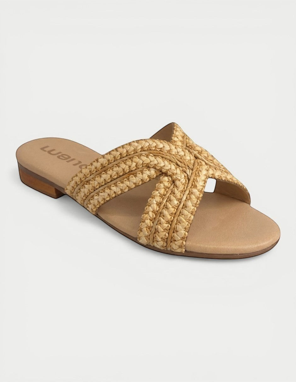 Manet Romy 01 natural woven raffia slide sandals with criss-cross straps and a comfortable flat sole.